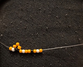 Image of a cat beaded ring being made