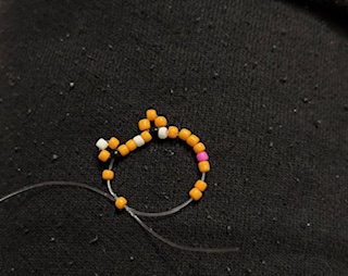 Image of a cat beaded ring being made