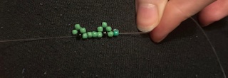 Image of frog beaded ring being made 