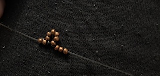 Image of a mouse beaded ring being made