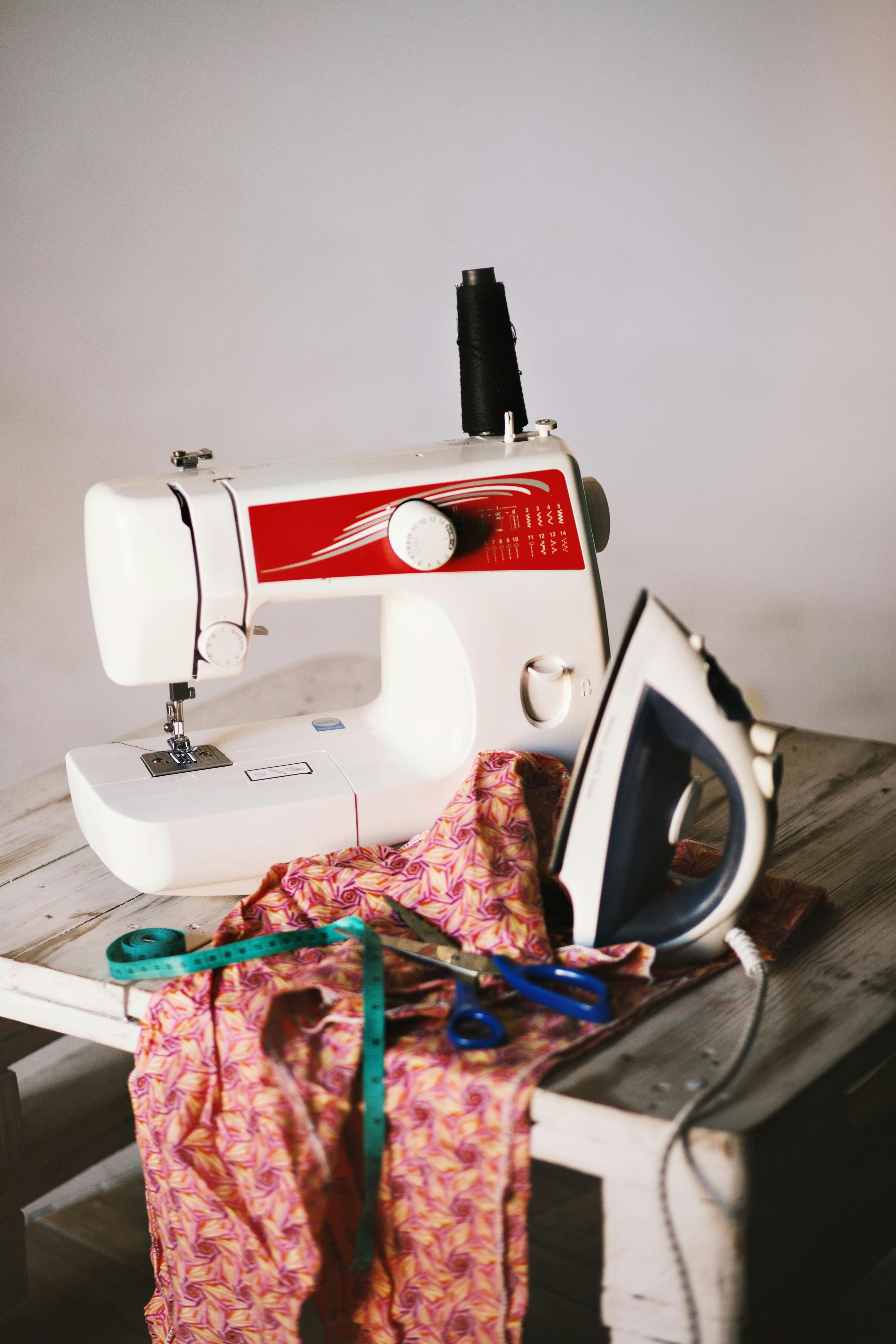Image of sewing machine on a table with an iron and some clothes