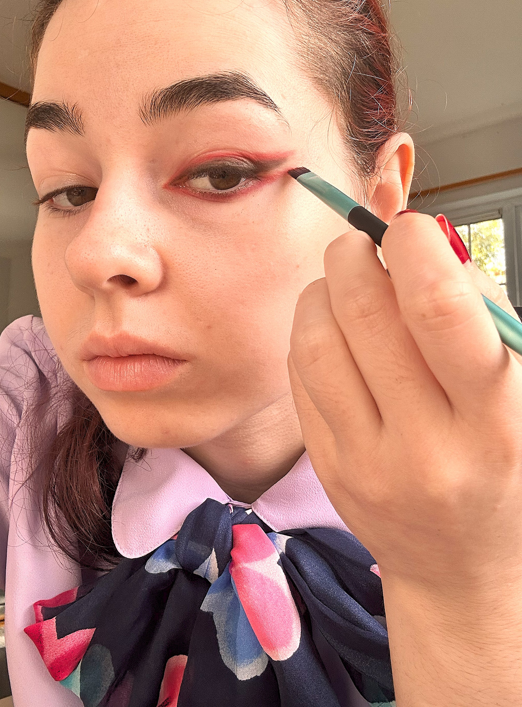 Applying red to the lower lash line 