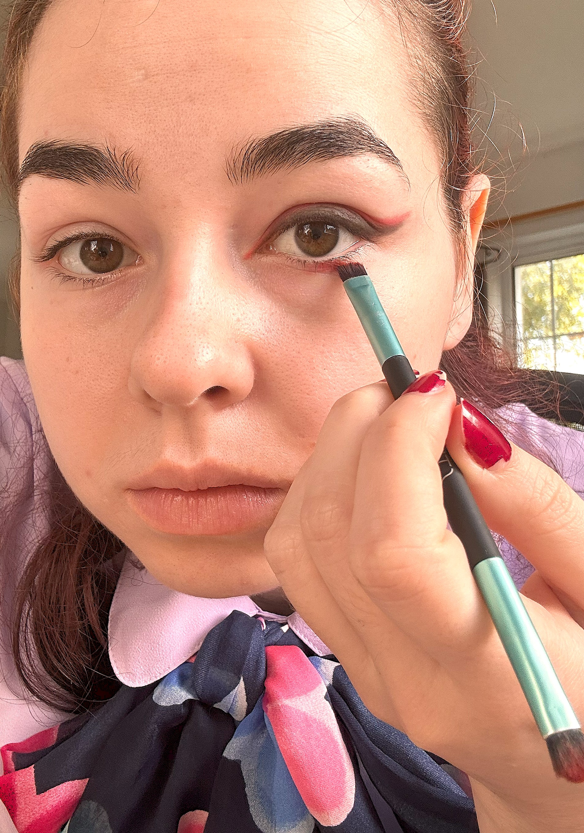 Applying red to the lower lash line 